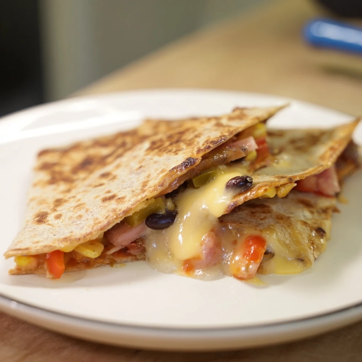 Quick Black Bean and Corn Quesadillas, a golden tortilla filled with melted cheese and savory beans.