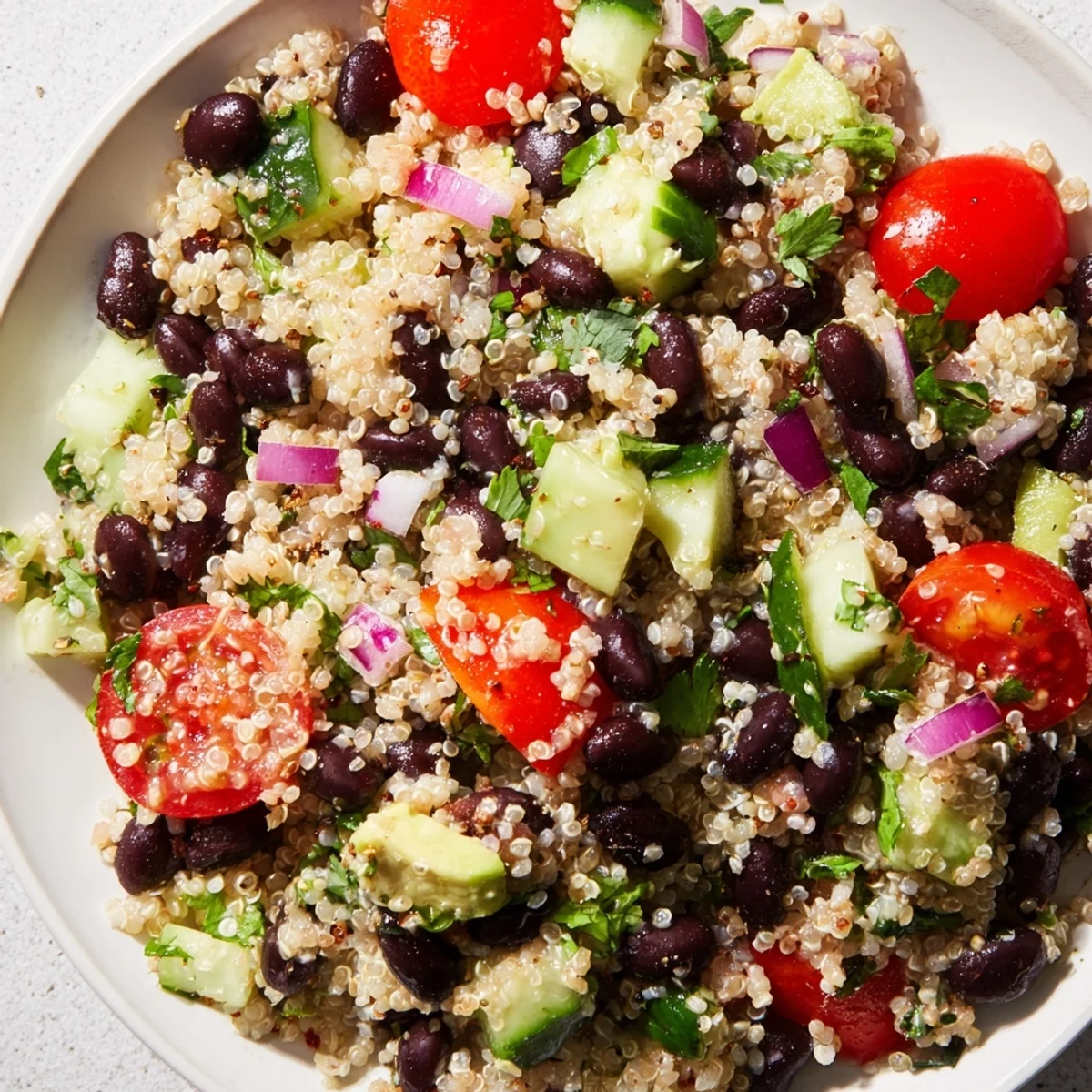 A colorful Quinoa Black Bean Salad, boasting fresh vegetables and a zesty lime dressing.