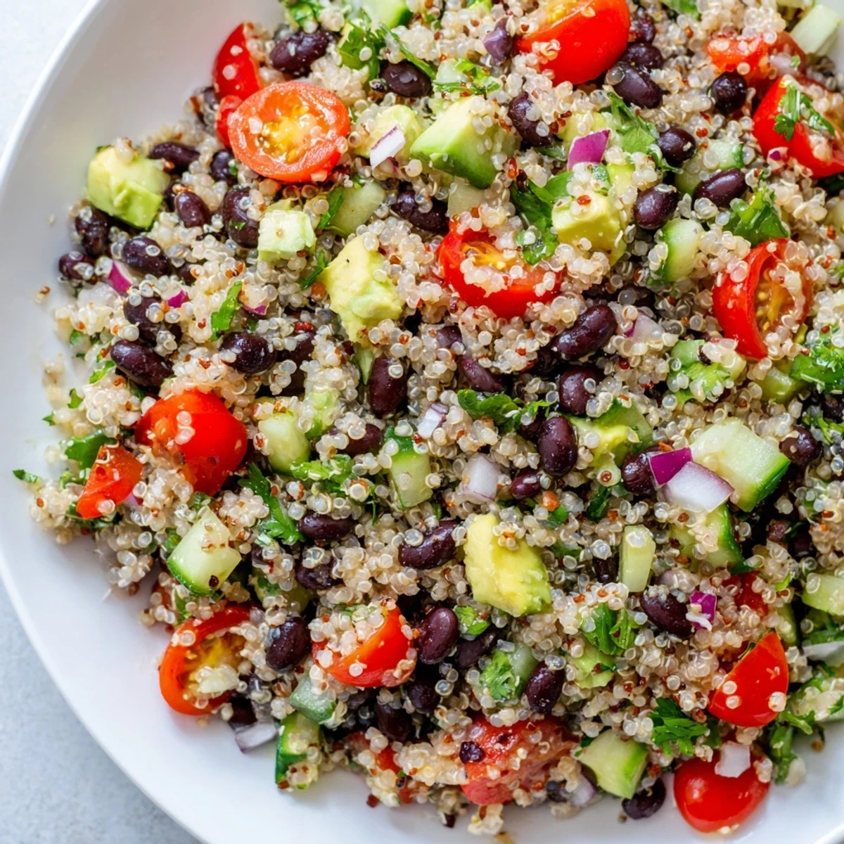 Enjoy a healthy bowl of Quinoa Black Bean Salad, with cilantro and a cumin-spiced dressing.
