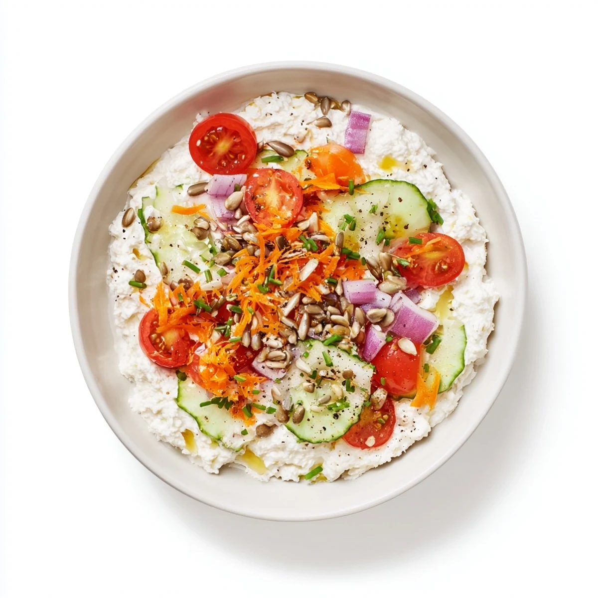 Savory cottage cheese snack bowl, drizzled with olive oil and seasoned for a delicious, quick bite.