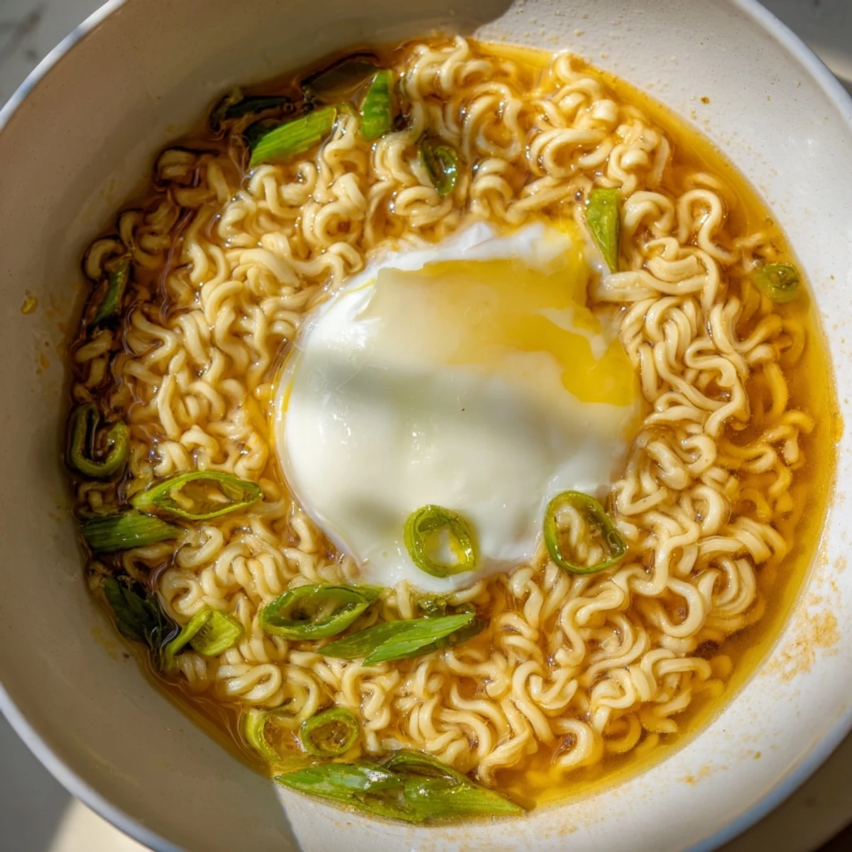 Flavor-packed instant ramen upgrade: a creamy, buttery broth with a runny egg and fresh scallions.
