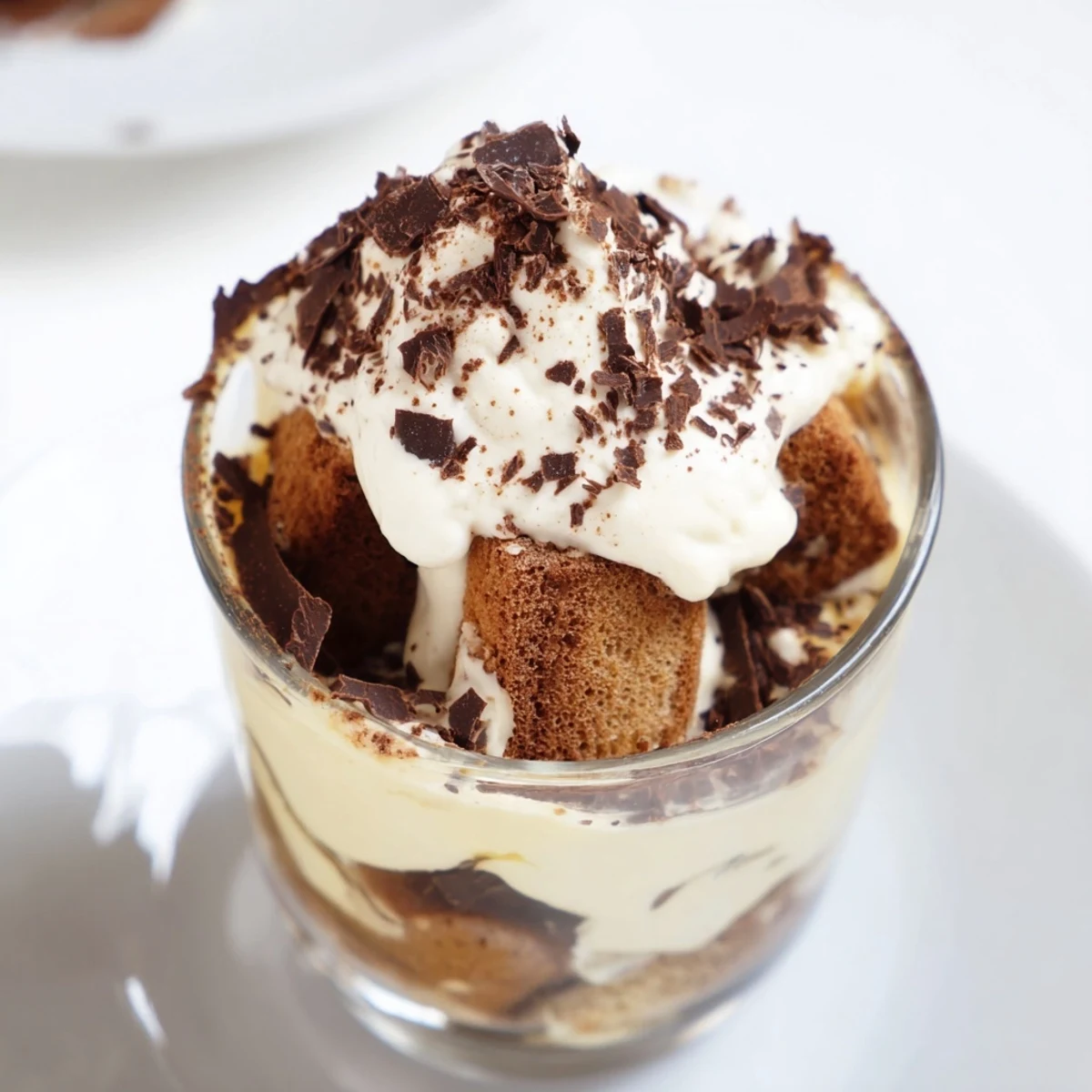 Deconstructed Tiramisu Shots in small glasses, dusted with cocoa and ready to serve for dessert.