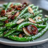 Tender green beans roasted to perfection with golden garlic slices, finished with a bright lemon twist for Easter dinner.  