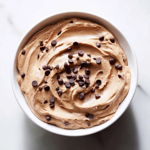 Rich, chocolatey Brownie Batter Dip, swirled with mini chocolate chips, ready for dipping treats.