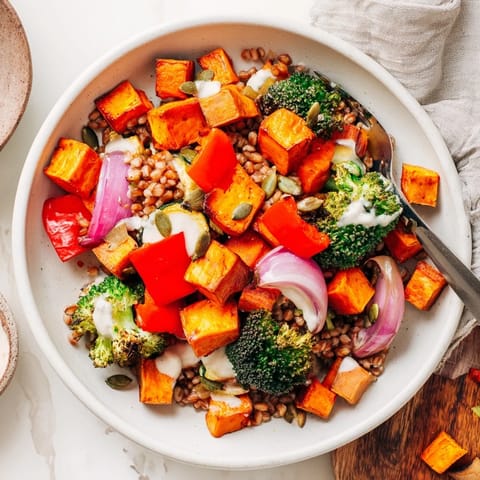 Vibrant image shows a Hearty Roasted Vegetable and Farro Grain Bowl with a beautiful medley of roasted vegetables, ready to eat.