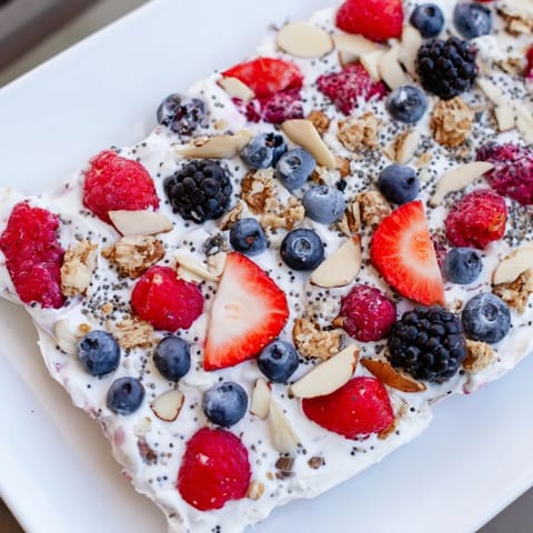 Delicious Frozen Fruit Yogurt Bark showcasing vibrant red berries and crunchy toppings perfect for snacking.