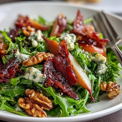 Frisée, Pear, Blue Cheese, and Crispy Prosciutto Salad: A refreshing bite with sweet pears and salty prosciutto atop tender frisée.