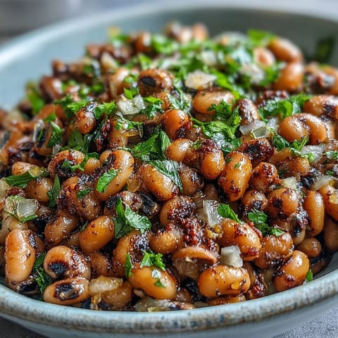 Savory Frozen Black-Eyed Peas simmered in a rich, smoky broth with onions, garlic, and fresh parsley garnish.