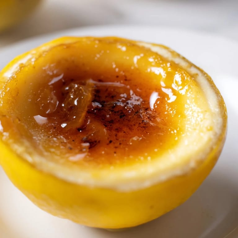 Refreshing chilled lemon brûlée posset, showcasing the smooth, velvety texture and caramelized sugar crust.