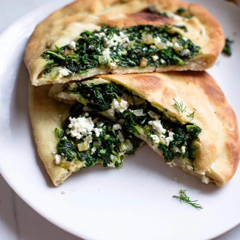 Freshly baked Turkish Spinach & Feta Flatbread, showcasing the flaky, golden crust and flavorful filling within.
