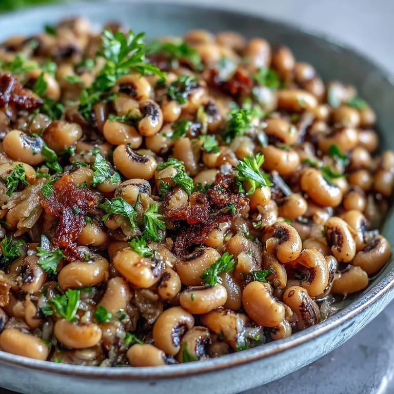 Hearty Southern Frozen Black-Eyed Peas stewed with thyme, paprika, and diced tomatoes, served alongside golden cornbread.