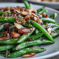 Roasted Garlic Green Beans with caramelized garlic and lemon zest, perfect for a savory Easter side dish.  